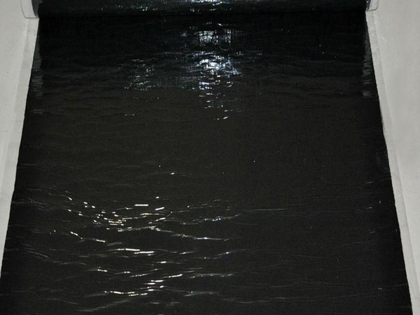 Self adhesive wet laid waterproofing membrane